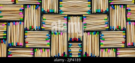 multicolored match sticks in boxes on a black background Stock Photo