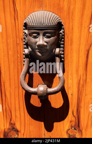 Egyptian Style Doorknob On A Wooden Door Seen In Siena Stock Photo