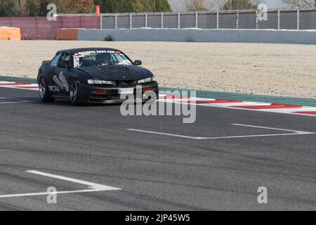 A drifting black tuning car on the race track  model Nissan Silvia S14 Stock Photo