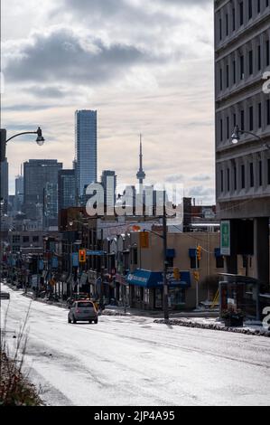 A vertical shot of the Yonge street in winter with frozen road and downtown Toronto in the back Stock Photo