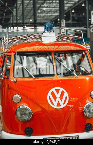 Front view of a fire fighting old vintage classic red volkswagen van with blue emergency light on top. Stock Photo