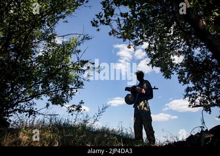 Kharkiv, Ukraine. 31st July, 2022. Silhouette of a warrior with a machine gun on guard at a combat post. Defense line of the Armed Forces of Ukraine near Kharkiv, Ukraine. Credit: SOPA Images Limited/Alamy Live News Stock Photo