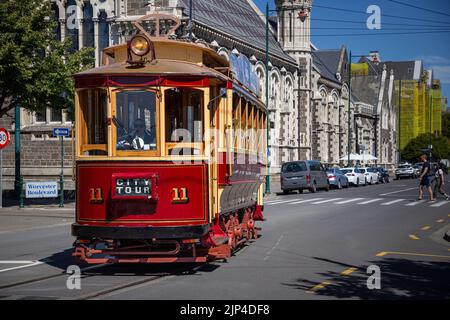 Street Tram turning onto Rolleston Avenue in front of The Arts Centre in Christchurch, New Zealand. Stock Photo