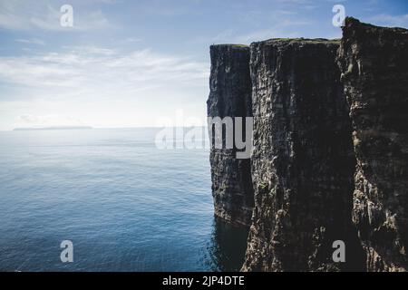 The Slave Cliff in the Faroe Islands on a calm day with a clear sky, Denmark Stock Photo