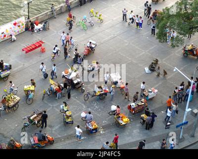 Guangzhou, China - November 6th 2013: Informal market stalls along the Pearl River with customers Stock Photo