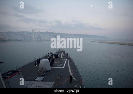 The guided missile destroyer USS Stout (DDG 55) prepares to pull into port in Haifa, Israel, Jan. 19, 2014, for a scheduled port visit 140119 Stock Photo