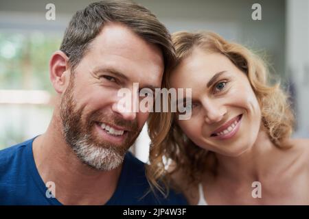 Theyre the perfect match. Portrait of a happy middle aged couple spending time together at home. Stock Photo