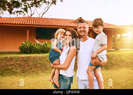 Family time is the happiest time. a young family spending time together outdoors. Stock Photo