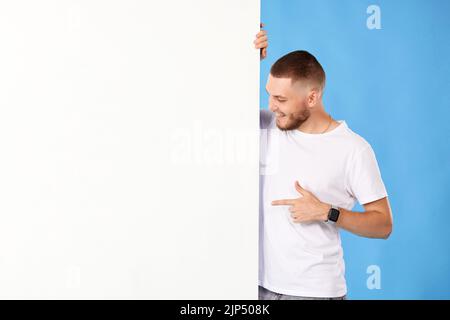 cheerful man holding board with empty copy space Stock Photo