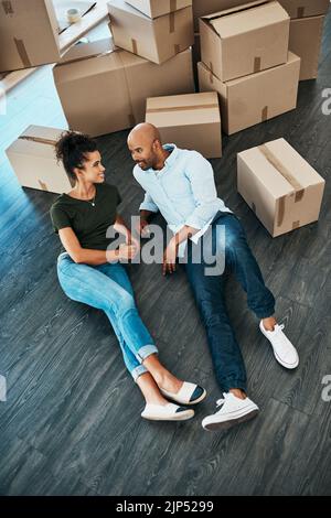 Taking a quick timeout during moving. a young couple taking a break while moving house. Stock Photo