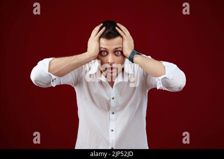 shocked man with round eyes, open mouth and hands Stock Photo
