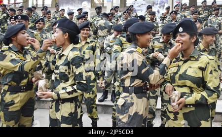 Amritsar, India. 16th Aug, 2022. AMRITSAR, INDIA - AUGUST 15: : Indian Border Security Force (BSF) women personnel offer sweets to each other on the occasion of the 76th Independence Day celebrations at Attari Wagah Border, on August 15, 2022 in Amritsar, India. (Photo by Sameer Sehgal/Hindustan Times/Sipa USA ) Credit: Sipa USA/Alamy Live News Stock Photo