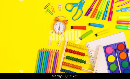 Back to school copy space with school stationery on vibrant yellow background. Flat lay Stock Photo