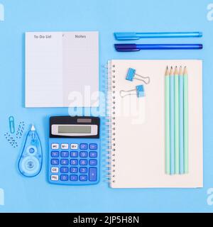 Back to school layout with school stationery in blue color on pastel blue background. Flat lay Stock Photo