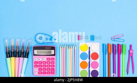 Creative arrangement of school stationery on pastel blue background. Back to school concept. Flat lay Stock Photo