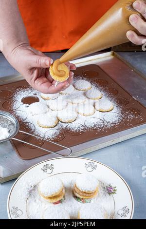 Confectioner filling with dulce de leche wedding sweet treat. Stock Photo