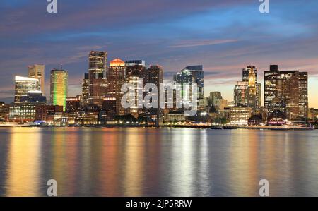 Boston skyline and harbor at dusk with Atlantic Ocean on the foreground, USA