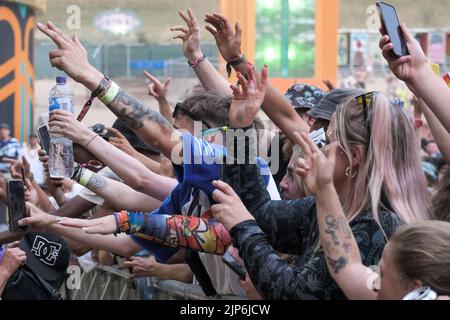 Winchester, UK. 14th Aug, 2022. Fans sing along with reggae artist Collie Buddz as he performs live on the Grand Central Stage at the Boomtown Fair Festival. Boomtown is a British music festival held every year on the Matterley Estate in South Downs National Park, near Winchester. Credit: SOPA Images Limited/Alamy Live News Stock Photo