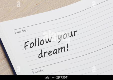 https://l450v.alamy.com/450v/2jp739t/follow-your-dream-diary-reminder-appointment-open-on-desk-2jp739t.jpg