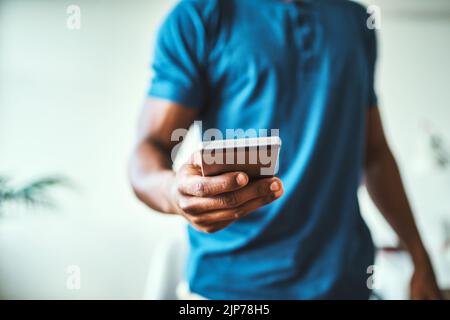 Keeping up with all his connections. Closeup shot of an unrecognizable man using a cellphone. Stock Photo