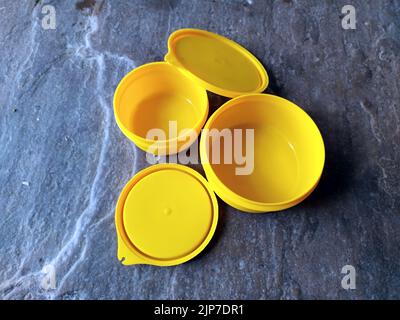 yellow plastic container box on stone background Stock Photo