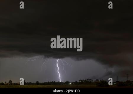 A summer storm with large lightnings over the Tuscan countryside of Bientina, Pisa, Italy Stock Photo