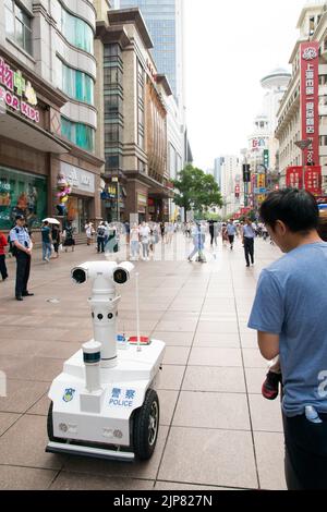 Shanghai's first robot police officer patrols Nanjing road pedestrian street, powered with advanced 5G technology and high definition cameras. Stock Photo