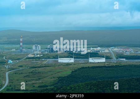 aerial view of plant for the production of liquefied natural gas in a natural area against the backdrop of mountains Stock Photo