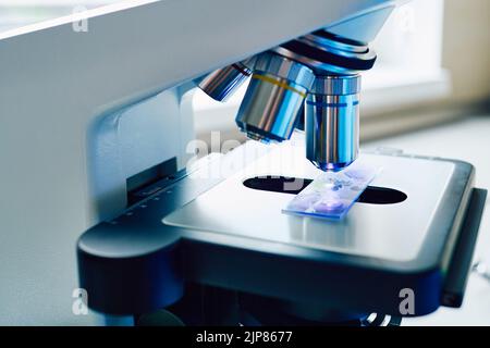 Research of test sample under medical microscope in laboratory, close-up Stock Photo