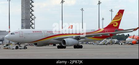 12 August 2022, Brandenburg, Schönefeld: An Airbus A330-300 aircraft of the Hainan airline stands on the tarmac of Berlin Brandenburg Airport ahead of the Chinese airline's maiden flight from BER. Photo: Wolfgang Kumm/dpa Stock Photo
