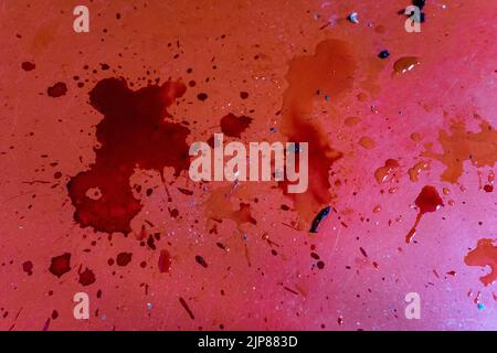 Spilled dark red liquid on red floor. Stock Photo