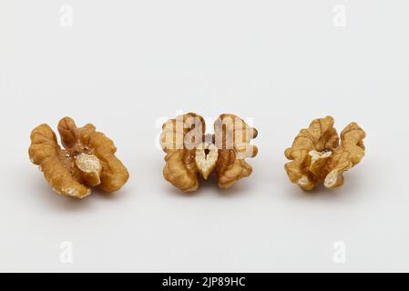 Three walnuts isolated on white background. Food texture concept Stock Photo