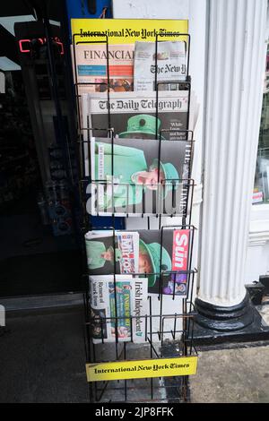 A newspaper rack holds commemorative issues about Queen Elizabeth's platinum jubilee celebration in June, 2022. In London, England, United Kingdom. Stock Photo