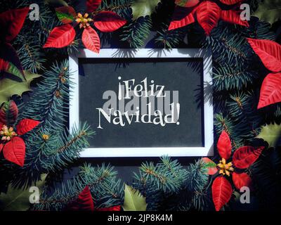 Feliz Navidad is Merry Christmas in Spanish language. Christmas festive background in red, black and dark green. Stock Photo