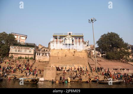 People bathing at Manmandir Ghat, Dolphin restaurant, Varanasi, Banaras, Benaras, Kashi, Uttar Pradesh, India Stock Photo