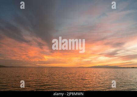 Sunset over the sea with cloudy and colorful beatiful sky view. Stock Photo