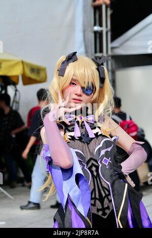 A vertical of an Asian female dressed like an anime character at Cosplay Festival in Ho Chi Minh, Vietnam Stock Photo