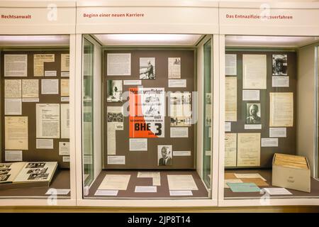 16 August 2022, Schleswig-Holstein, Schleswig: Display cases with documents and pictures hang in the Schleswig-Holstein State Archives. On August 17, 2022, the exhibition 'Heinz Reinefarth. From Nazi War Criminal to Member of the State Parliament' will open. Reinefarth was a German lieutenant general in the Waffen SS and was responsible for, among other things, the suppression of the Warsaw Uprising, during which tens of thousands of civilians were shot under his command. Reinefarth was never prosecuted for his actions. He managed to embark on a political career, becoming a member of the Schle