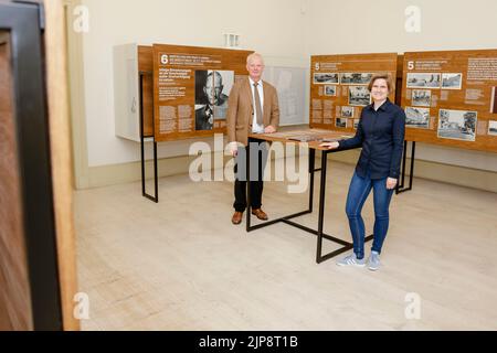 16 August 2022, Schleswig-Holstein, Schleswig: Rainer Hering, Senior Archive Director of the Schleswig-Holstein State Archives, and curator Julia Liedtke, stand at a table. On August 17, 2022, the exhibition 'Heinz Reinefarth. From Nazi War Criminal to Member of the State Parliament' will open. Reinefarth was a German lieutenant general in the Waffen SS and was responsible for, among other things, the suppression of the Warsaw Uprising, in which tens of thousands of civilians were shot under his command. Reinefarth was never prosecuted for his actions. He managed to embark on a political caree