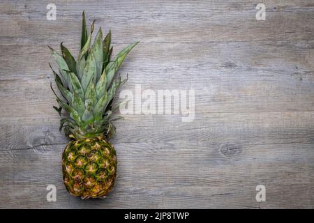 Whole pineapple on a wooden table Stock Photo