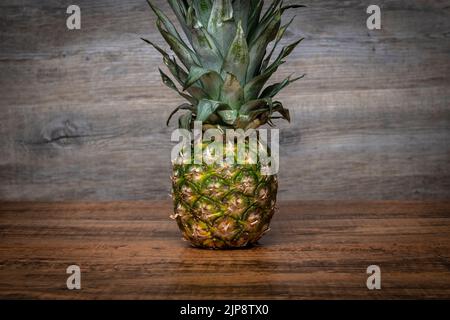 Pineapple on a wooden table Stock Photo