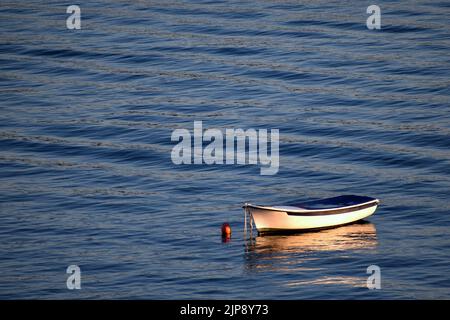 Small fishing boat moored on clamed waters near Tisno, Murter Island, in Croatia Stock Photo