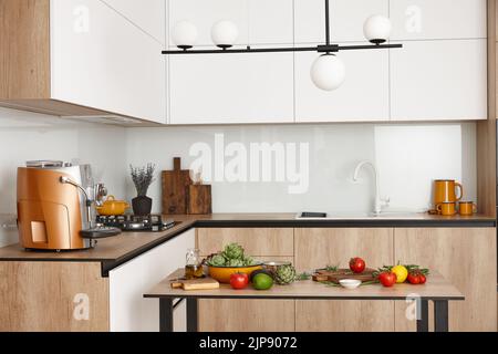 Modern loft-style kitchen ready for cooking, copy space Stock Photo