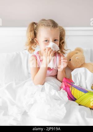 The child himself blows snot into a napkin. Stock Photo