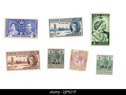 A selection of old mint postage stamps from British Honduras on a white background. Stock Photo