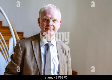 16 August 2022, Schleswig-Holstein, Schleswig: Rainer Hering, Senior Archive Director of the Schleswig-Holstein State Archives, looks on for a portrait photo. On August 17, 2022, the exhibition 'Heinz Reinefarth. From Nazi War Criminal to Member of the State Parliament' will open. Reinefarth was a German lieutenant general in the Waffen SS and was responsible for, among other things, the suppression of the Warsaw Uprising, in which tens of thousands of civilians were shot under his command. Reinefarth was never prosecuted for his actions. He managed to embark on a political career, becoming a
