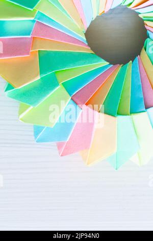 Origami ring, top view. Abstract parametric structure made of colorful paper sheets. Close up vertical photo with selective soft focus