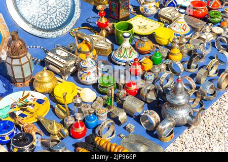 Moroccan craft souvenirs on street market. Teapots, jewelry, tagines, trinkets Stock Photo