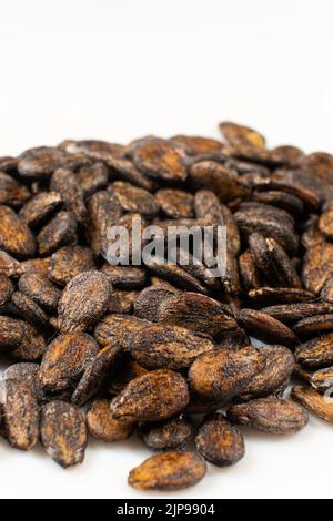 Dried watermelon seeds on a white background macro top view. Stock Photo