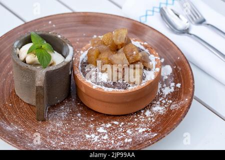 Souffle with chestnut in a casserole and ice cream with cream Stock Photo